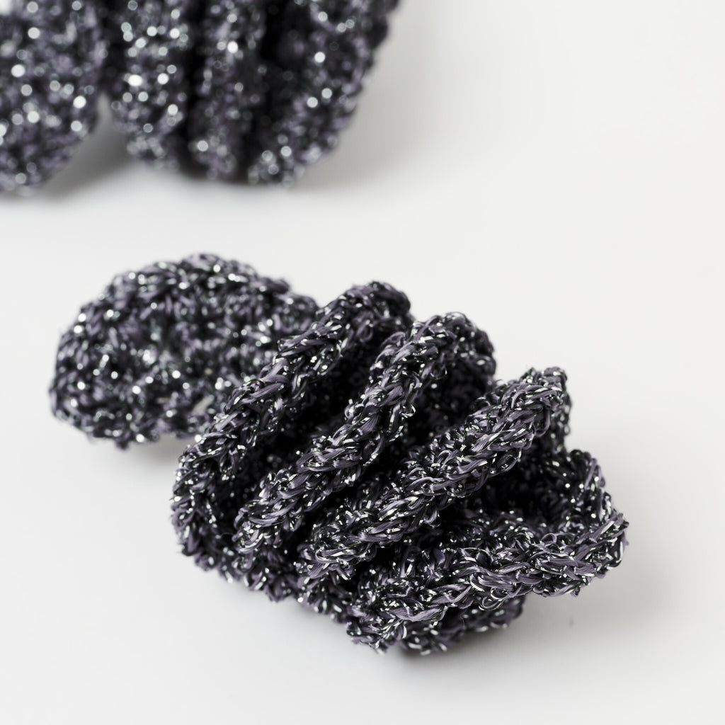 The Elara spiral drop earrings in Graphite Grey with silver shimmer, close up - Lodorfo