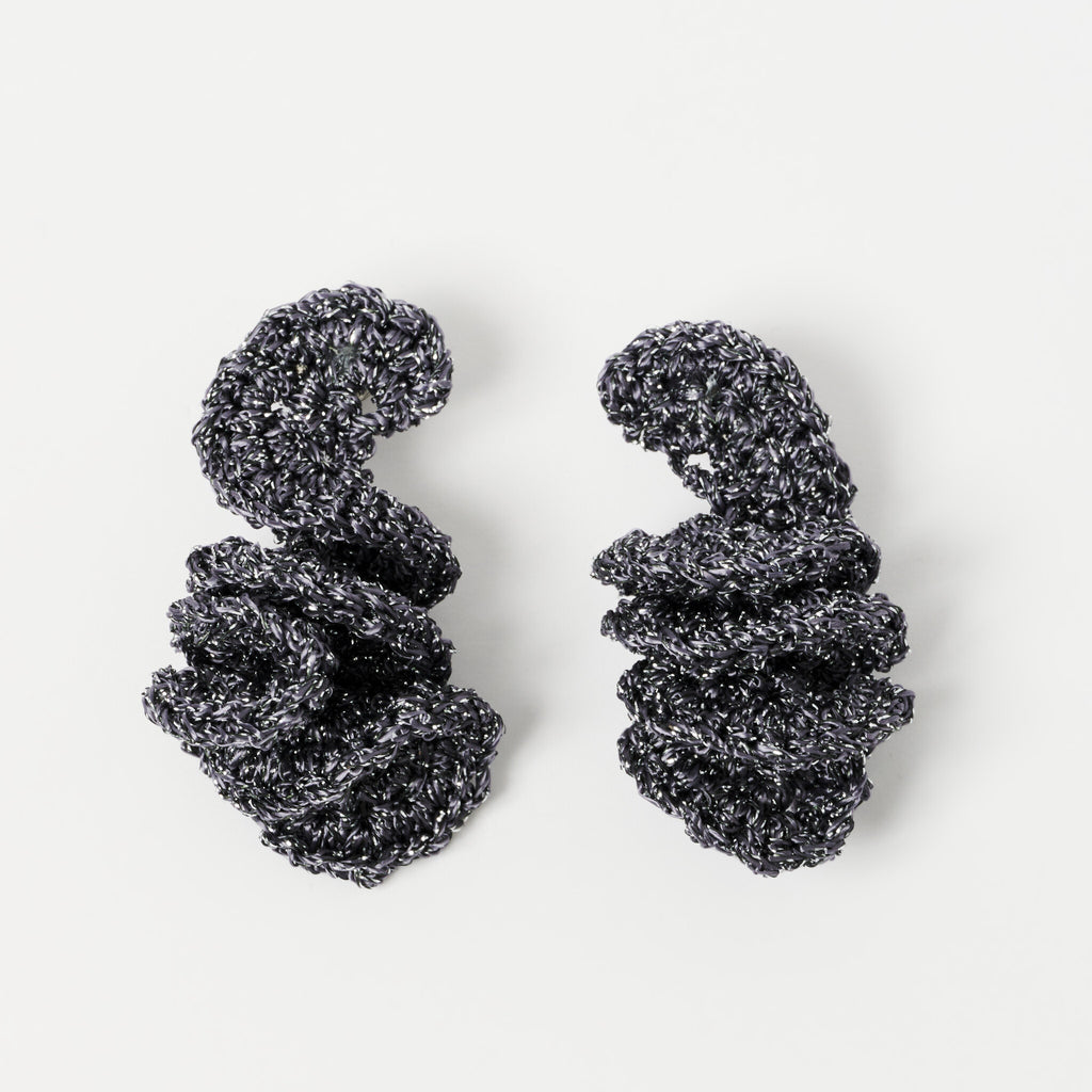 The Elara spiral drop earrings in Graphite Grey with silver shimmer, flat lay - Lodorfo