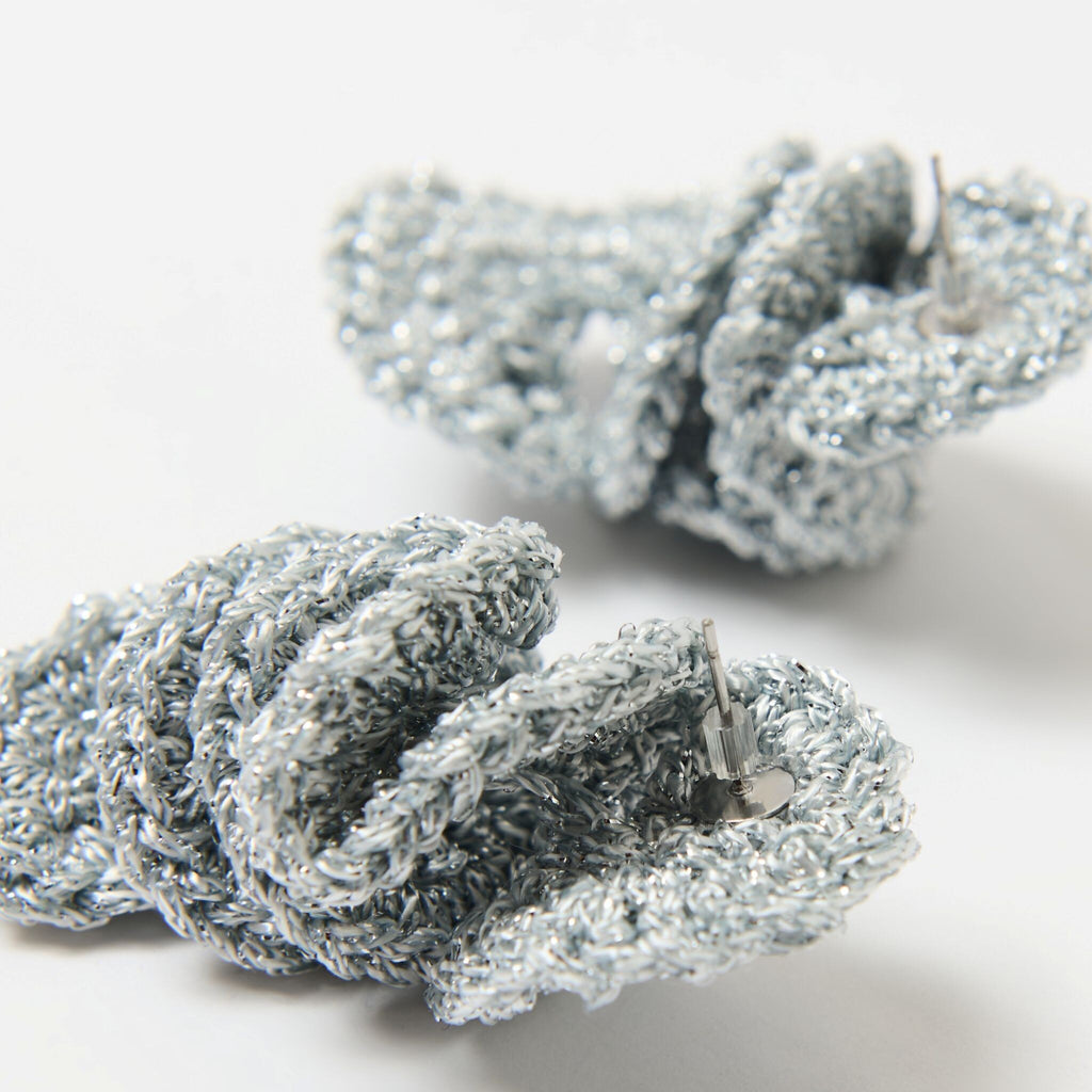 The Elara spiral drop earrings in Silver Grey with silver shimmer, close up of crochet detail - Lodorfo