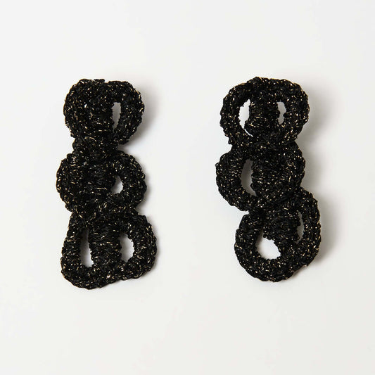 Front view of handcrafted black crochet loop earrings with a glossy, metallic sheen, featuring interlocking circular shapes on a white background.