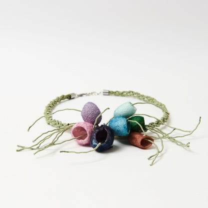 Colorful necklace with silk cocoons on a white background