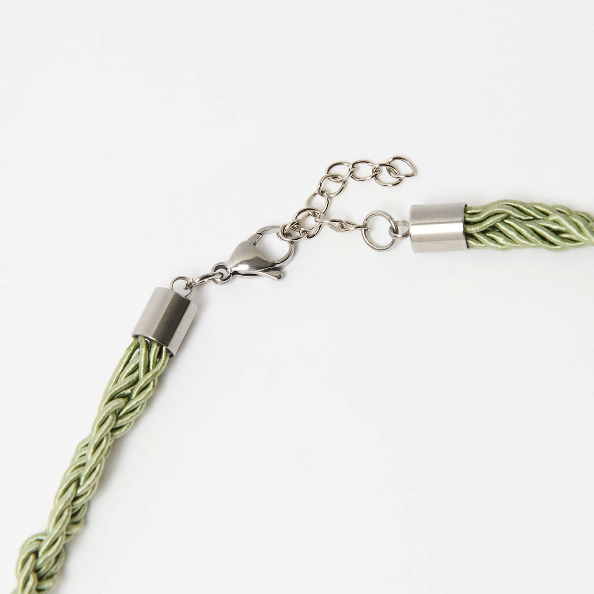 Detail of the Luma clasp, silver end cap and extender chain on the plaited sage green cord - Lodorfo