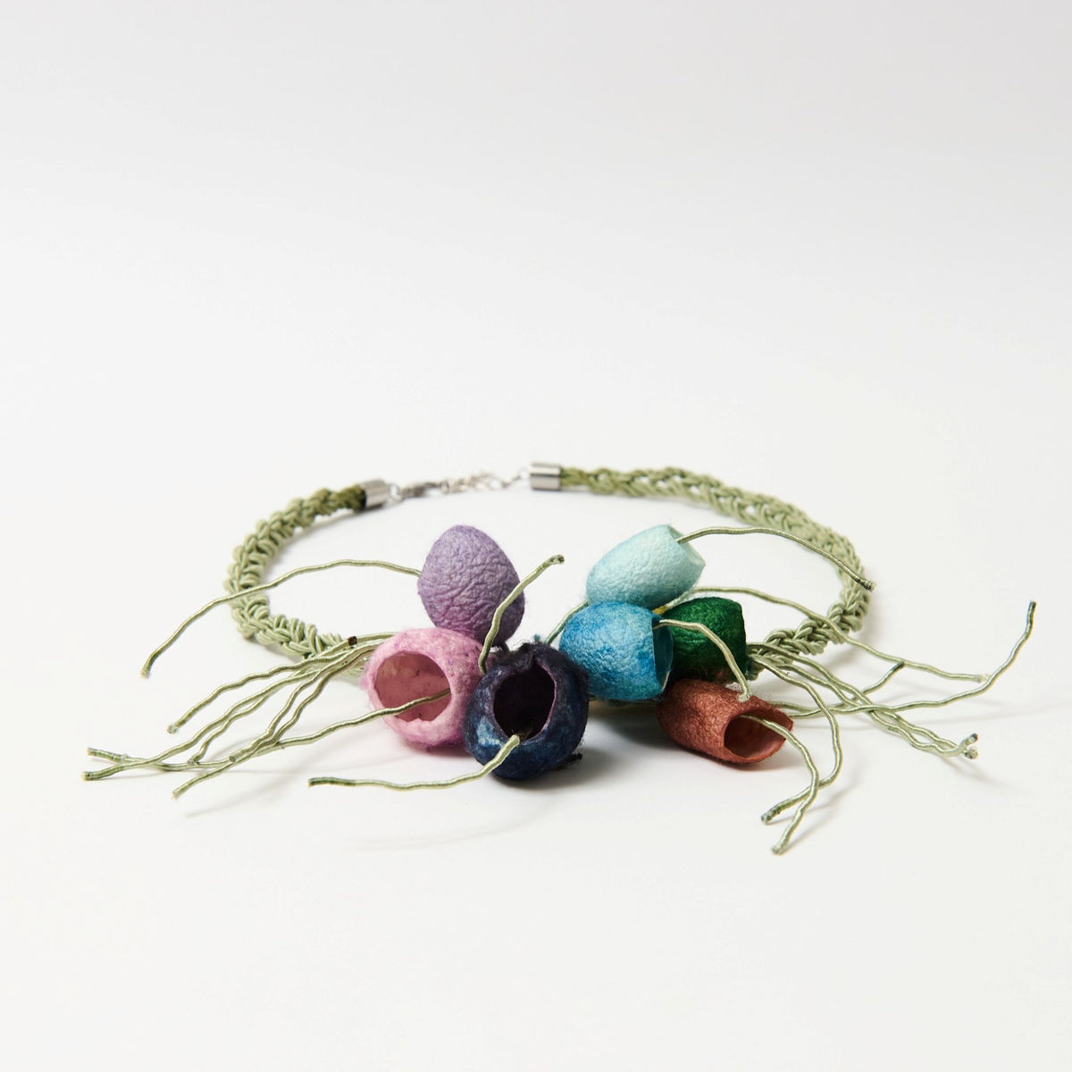Side angle of the Luma silk cocoon necklace, multicolour cocoons and wire tendrils on a sage green plaited cord - Lodorfo