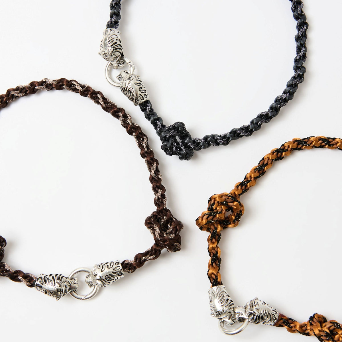 The Kaelis necklaces in midnight black, chestnut brown and burnt orange laid out side by side - Lodorfo