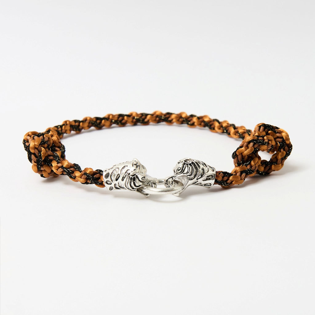 Side angle of the Kaelis burnt orange wave-braided necklace with two silver tiger heads joined by a ring - Lodorfo