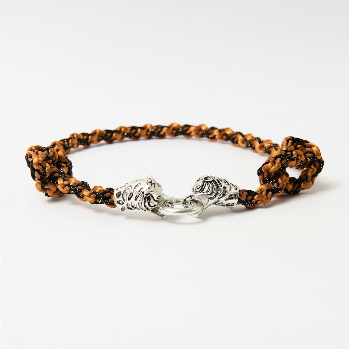 Side angle of the Kaelis burnt orange wave-braided necklace with two silver tiger heads joined by a ring - Lodorfo