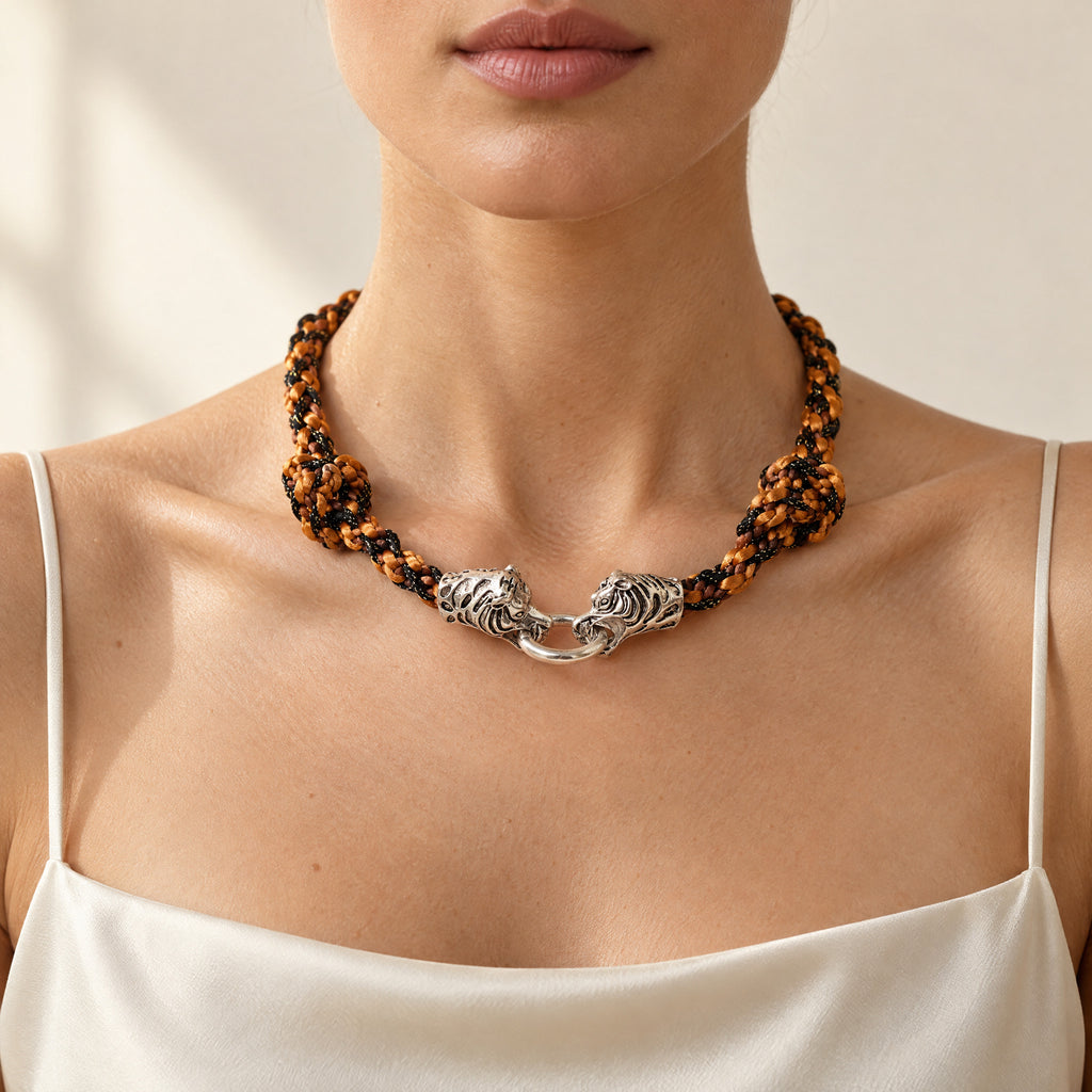 Woman wearing the Kaelis burnt orange wave-braided necklace with silver tiger head clasp, handmade UK - Lodorfo