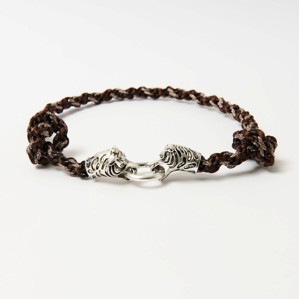 Side angle of the Kaelis chestnut brown wave-braided necklace with two silver tiger heads joined by a ring - Lodorfo