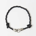 The Kaelis midnight black wave-braided necklace with silver tiger head clasp, laid flat - Lodorfo