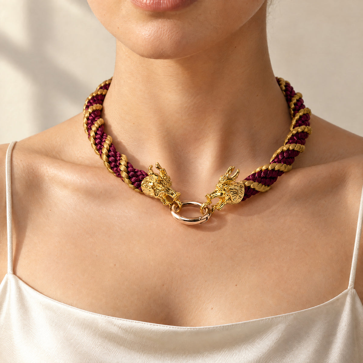 Woman wearing the Drakon crimson red satin-braided rope necklace with antique-gold spiral and dragon head clasp, handmade UK - Lodorfo