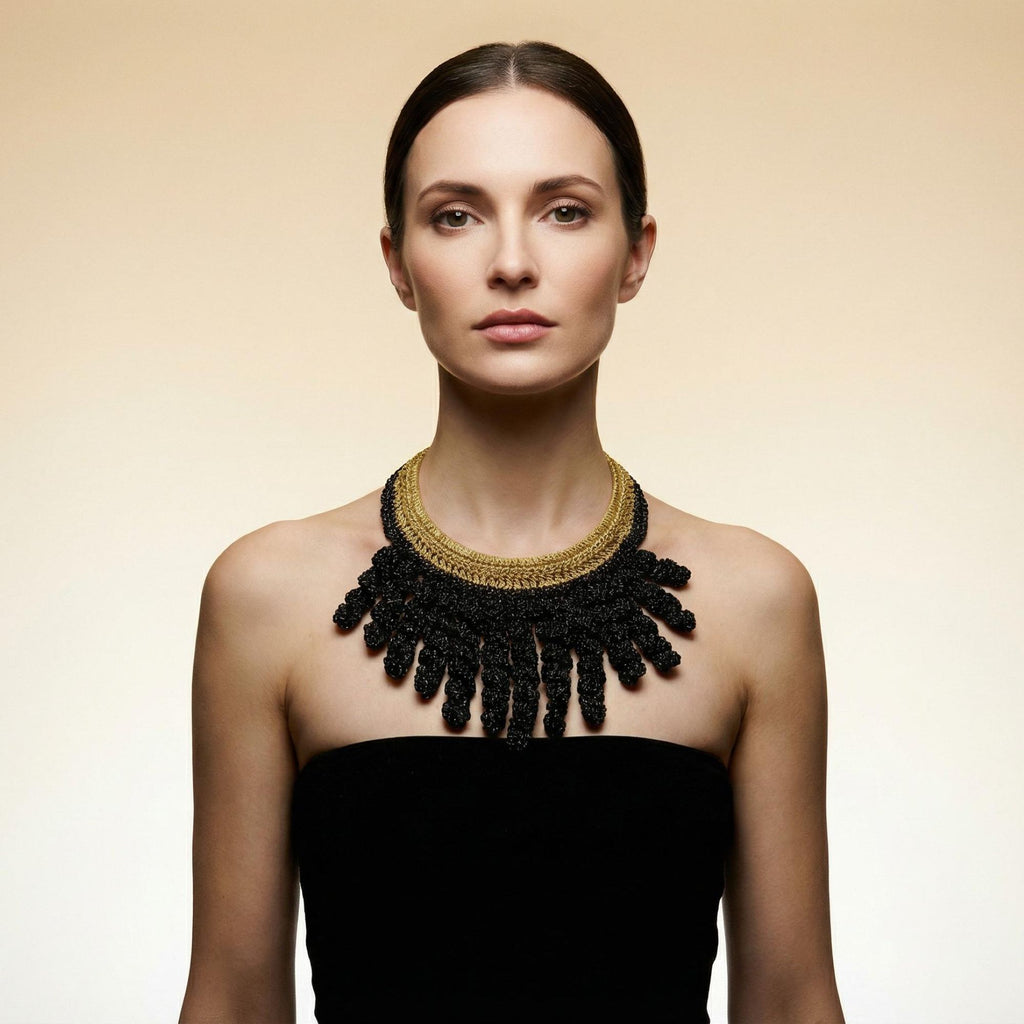 Woman with her hair back wearing the Vetra midnight black and antique gold crochet collar necklace - Lodorfo