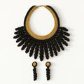The Vetra Edit set: Vetra black and antique gold crochet collar necklace with Noire gold drop earrings, laid flat - Lodorfo