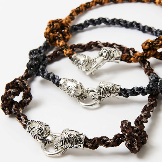Three braided necklaces with silver clasp on a white background