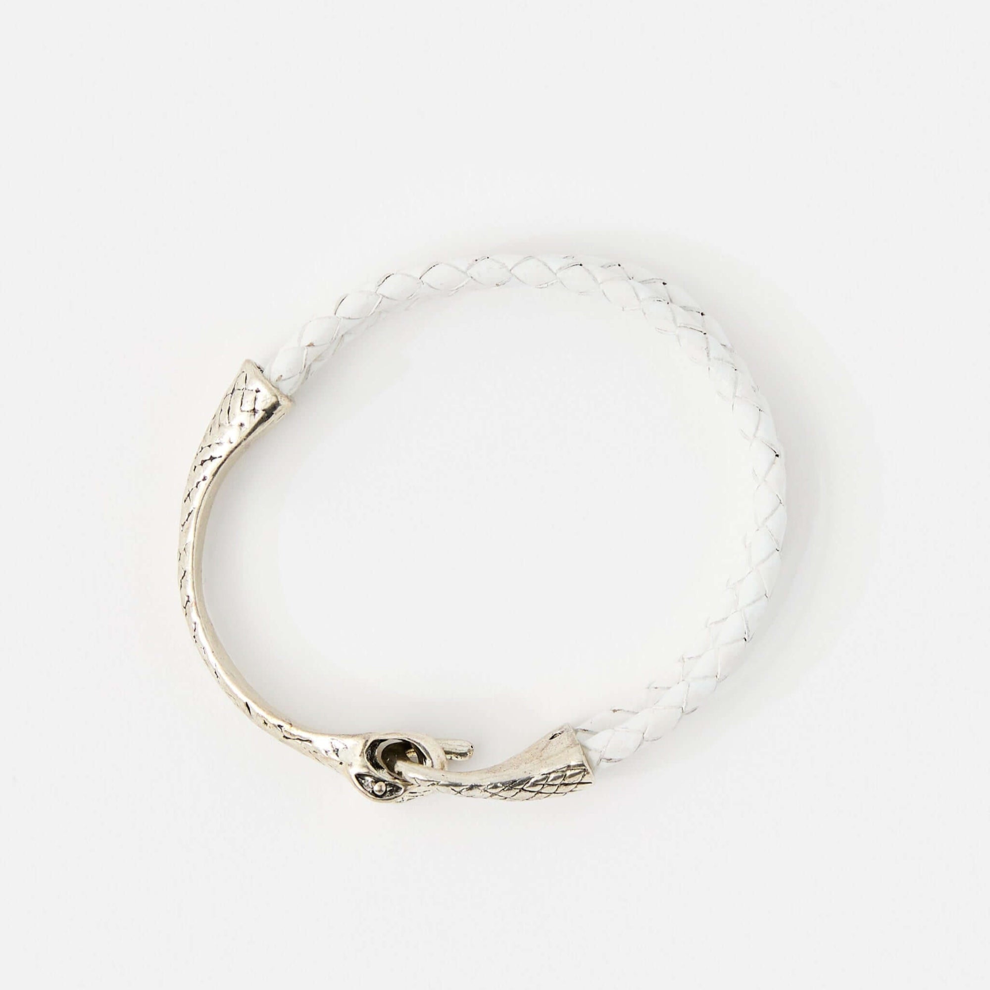 Top view of a white braided leather bracelet with a silver snake head clasp, featuring intricate scale details and a sleek, minimalistic design.