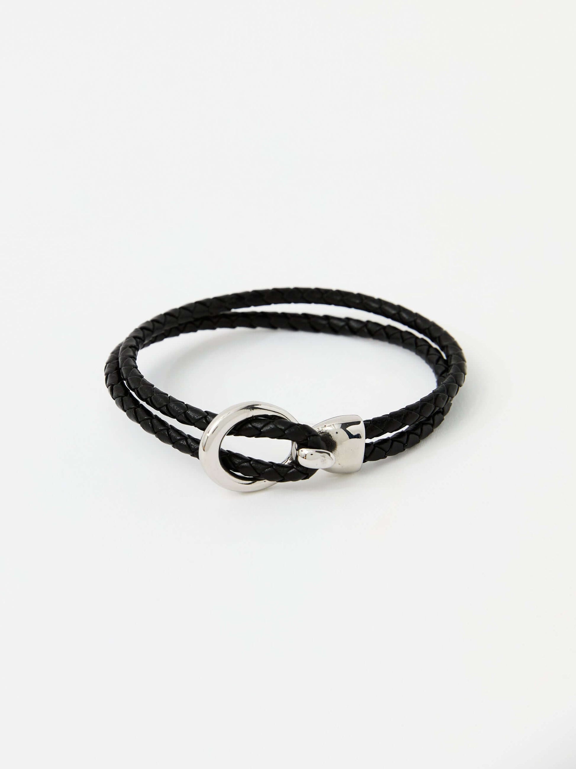 Black braided leather bracelet with a sleek silver loop and knot clasp, showcasing a modern and minimalist style.