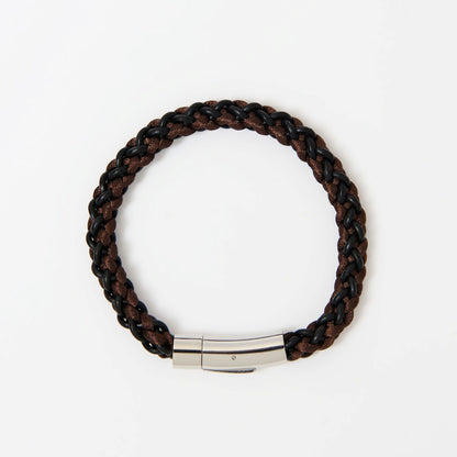 Brown braided bracelet with a silver clasp on a white background