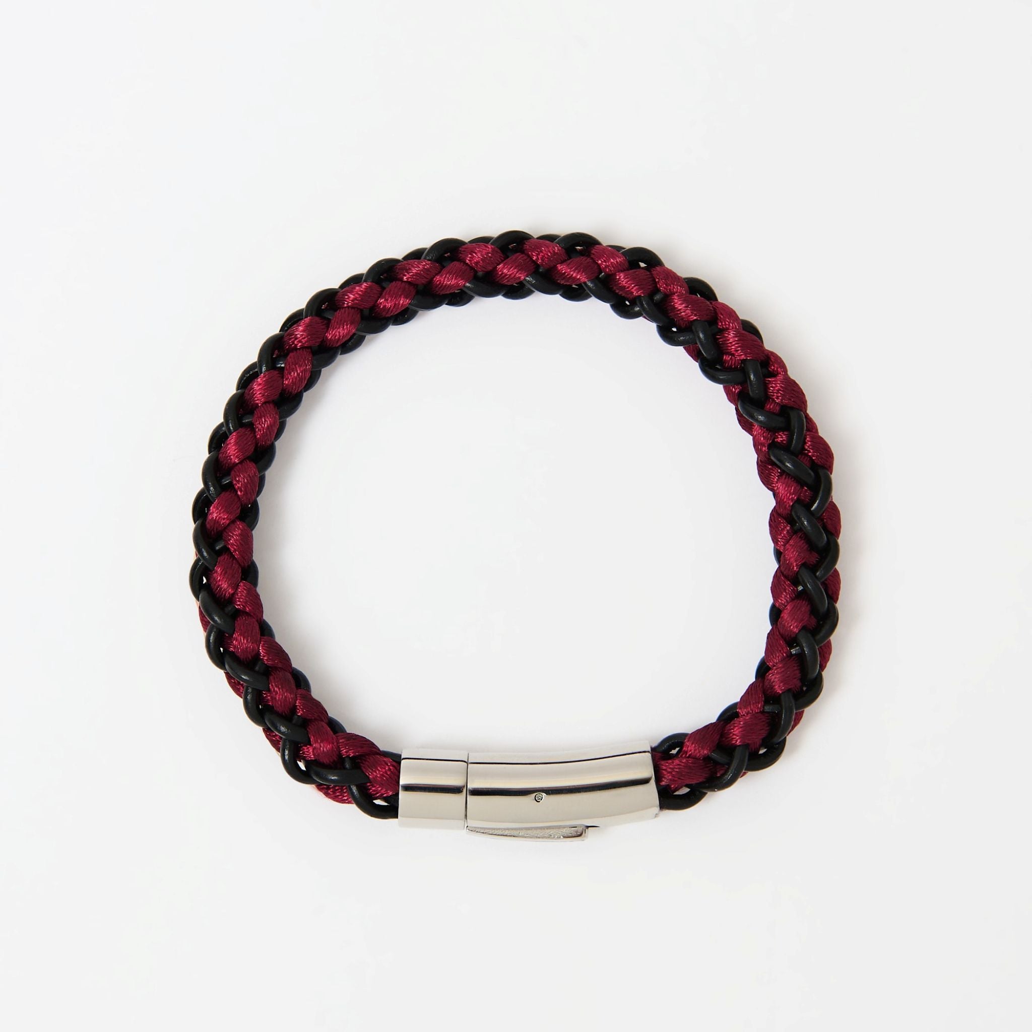 Braided red and black bracelet with a silver clasp on a white background