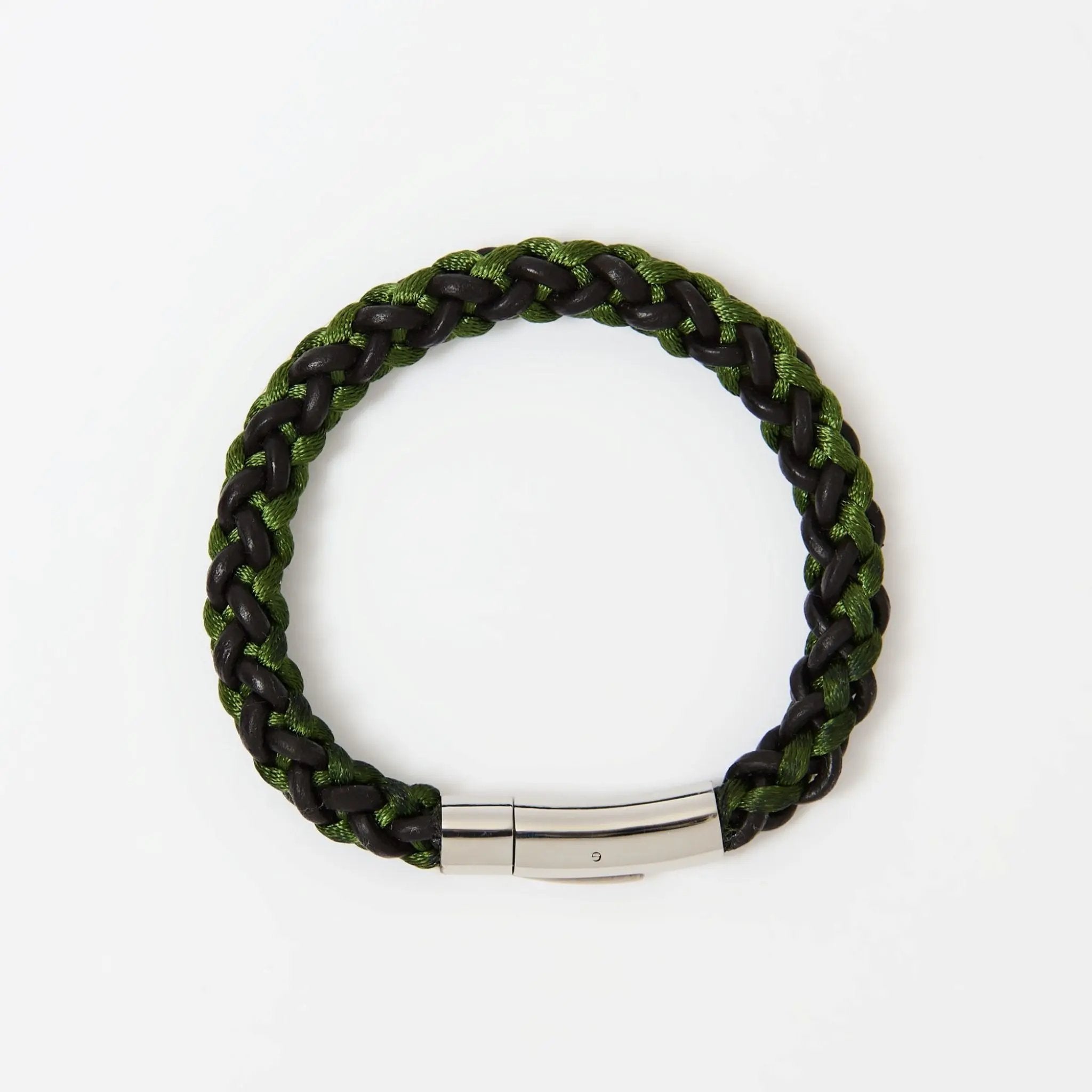 Close-up of braided green and brown  leather men’s bracelet with polished stainless steel clasp — vibrant accessory with modern edge.