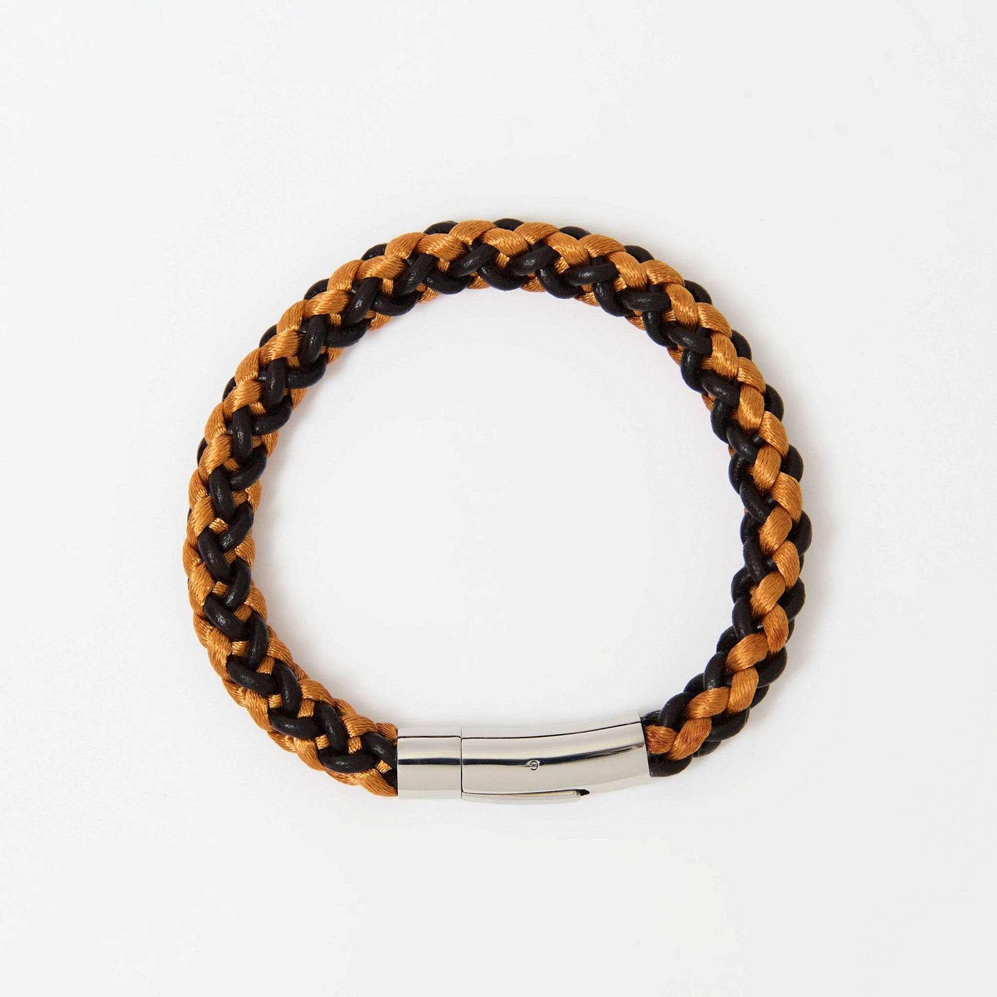 Close-up of orange and brown braided leather men’s bracelet with polished stainless steel clasp — vibrant accessory with modern edge.