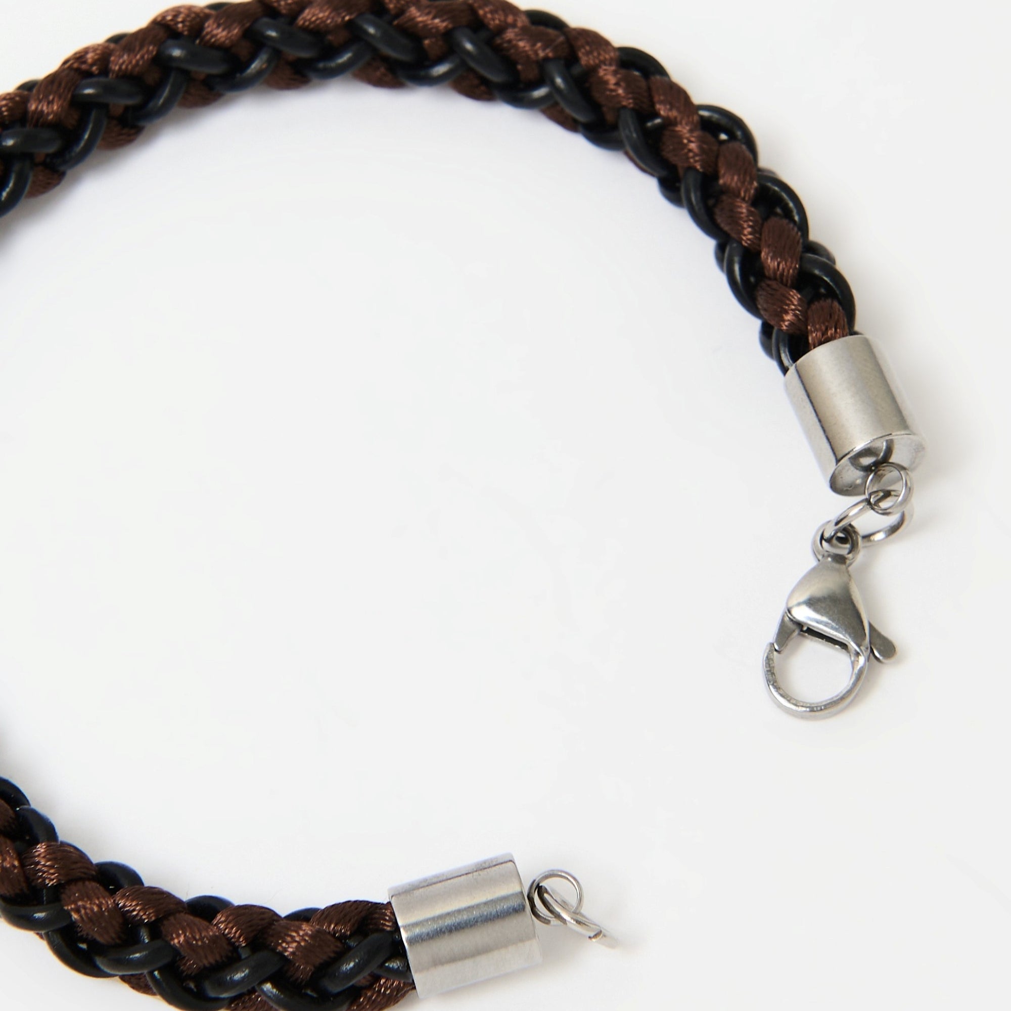 Detail shot of brown and black braided leather bracelet with polished stainless steel lobster clasp — premium men’s wristwear showcasing secure fastening.