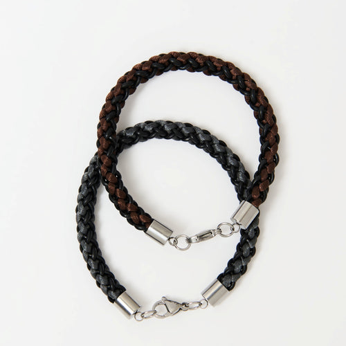 Pair of men’s braided leather and silk bracelets in brown/black and grey/black, featuring stainless steel lobster clasps — modern accessory duo for versatile styling.