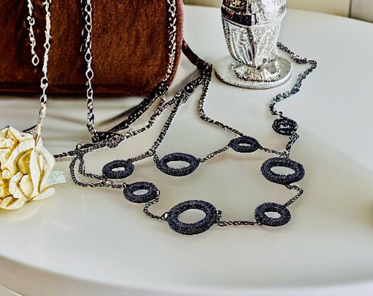 Charcoal rings necklace placed on a dressing table.