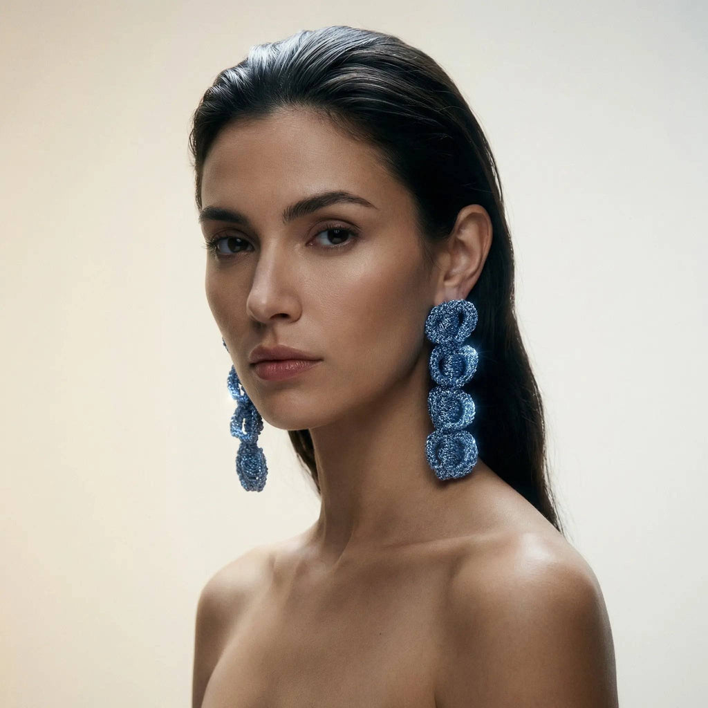 The Arlo sculptural loop earrings, styled on a model — Lodorfo