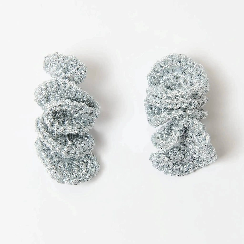 The Elara silver spiral dangle earrings, product flat lay — Lodorfo