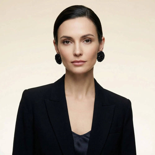 The Vela handcrafted disc earrings, styled on a model — Lodorfo